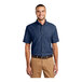 A man wearing a Port & Company ink blue long sleeve denim button-down shirt.