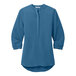 A Port Authority women's blue short sleeve blouse.