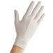 A person's hand wearing a Bluzen white powdered latex glove.