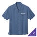 A Port Authority blue short sleeve camp shirt with a logo on it.