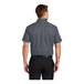 A man wearing a Port Authority steel gray and light stone short sleeve dress shirt.