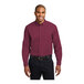 A man wearing a Port Authority long sleeve burgundy and light stone poplin dress shirt.