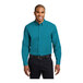 A man wearing a Port Authority teal green long sleeve dress shirt.