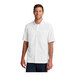 A man wearing a white Port Authority UV Daybreak shirt.