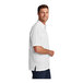 A man wearing a white Port Authority short sleeve shirt.