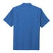 A Port Authority True Blue short sleeve performance staff shirt.