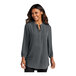 A woman wearing a graphite Port Authority short sleeve blouse.
