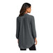 A woman wearing a graphite Port Authority short sleeve blouse.