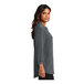 A woman wearing a graphite short sleeve Port Authority blouse.