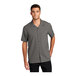 A man wearing a graphite grey Port Authority short sleeve staff shirt.