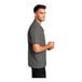 A man wearing a graphite Port Authority staff shirt.