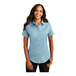 A woman wearing a light blue Port Authority short sleeve dress shirt.
