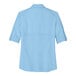 A light blue Port Authority short sleeve shirt for women with rolled up sleeves.