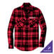 A Port Authority red and black plaid flannel shirt on a table.