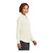 A woman wearing a Brooks Brothers off white satin button-down shirt.