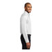 A man wearing a white Port Authority long sleeve dress shirt.