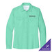 A Port Authority women's long sleeve aqua shirt with a logo on the chest.