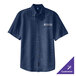 An ink blue Port & Company short sleeve denim button-down shirt on a table with a University of Texas logo.