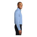 A man wearing a light blue Port Authority dress shirt.