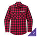 A red and black plaid Port Authority flannel shirt on a table.