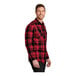 A man wearing a Port Authority red and black plaid flannel shirt.