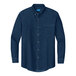 A Port & Company blue short sleeve denim button-down shirt on a counter.