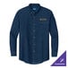 A Port & Company long sleeved denim shirt in blue with an embroidered logo.