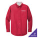 A red Port Authority long sleeve dress shirt on a counter.