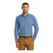 A man wearing a faded blue Port & Company short sleeve denim button-down shirt.