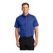 A man wearing a Port Authority royal blue short sleeve dress shirt.