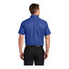 A man wearing a Port Authority royal blue and navy short sleeve dress shirt.