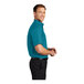 A man wearing a teal green Port Authority short sleeve dress shirt.
