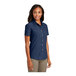 A woman wearing a Port & Company ink blue short sleeve denim button-down shirt.