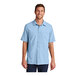 A man wearing a light blue Port Authority short sleeve shirt.