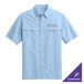 A light blue short sleeve Port Authority shirt with gold embroidery.