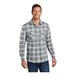 A man wearing a gray and cream plaid Port Authority flannel shirt with the sleeves rolled up.