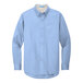 A Port Authority light blue long sleeved button down dress shirt.