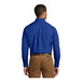 A man wearing a Port Authority true royal blue long sleeve poplin dress shirt.