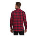 A man wearing a Port Authority red and black buffalo check flannel shirt.