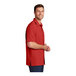 A man wearing a Port Authority red short sleeve performance shirt.