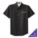A black Port Authority short sleeve dress shirt with gold embroidery on the front.