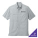 A grey Port Authority short sleeve shirt with a logo on the chest.