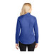 A woman wearing a royal blue Port Authority long sleeve dress shirt.