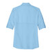 A light blue Port Authority short sleeve shirt with rolled up sleeves.