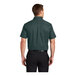 A man wearing a dark green and navy Port Authority short sleeve dress shirt.