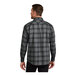 A man wearing a gray and black plaid Port Authority flannel shirt.