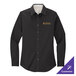 A small black Port Authority women's long sleeve dress shirt on a table with gold embroidery.
