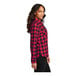 A woman wearing a red and black Port Authority flannel shirt.