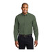 A man wearing a Port Authority clover green long sleeve poplin shirt.