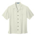 A white Port Authority camp shirt with buttoned collar and two buttons.